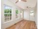 Bright sunroom with wood floors, multiple windows, and access to the outdoors at 235 River Loop Rd, Belmont, NC 28012