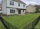 Spacious, fenced backyard features a covered patio and a well-maintained lawn at 248 Aylesbury Ln, Indian Trail, NC 28079