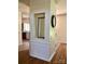 Hallway featuring a decorative mirror and clock, with views of the kitchen and living area at 248 Aylesbury Ln, Indian Trail, NC 28079