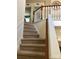 Carpeted staircase with wooden banister and white spindles leading to the second floor at 248 Aylesbury Ln, Indian Trail, NC 28079