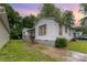 Charming white home with dark trim, showcasing a quaint yard and inviting front porch at 2622 Hemphill St, Charlotte, NC 28208