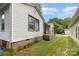 Side view of a home, showcasing the siding, foundation, and walkway at 2622 Hemphill St, Charlotte, NC 28208