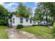 Home with white siding, featuring a well-maintained lawn and concrete driveway at 2622 Hemphill St, Charlotte, NC 28208