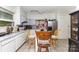 Cozy kitchen featuring white cabinets, a stainless steel refrigerator, and a small island with seating at 2622 Hemphill St, Charlotte, NC 28208