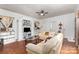 Cozy living room with hardwood floors, sofas, built in shelves, and a ceiling fan at 2622 Hemphill St, Charlotte, NC 28208