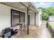 Covered porch area with seating and convenient access to the home's entrance at 2622 Hemphill St, Charlotte, NC 28208