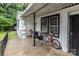 Covered porch with seating, table and storage, offering an outdoor area at 2622 Hemphill St, Charlotte, NC 28208