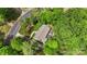 Overhead view of lush property with a well-kept lawn, mature trees, and a meticulously designed landscape at 301 Deer Creek Dr, Matthews, NC 28105
