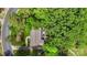 Aerial view of lush landscaped property featuring a large, well-maintained lawn and mature trees providing privacy at 301 Deer Creek Dr, Matthews, NC 28105