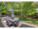 Backyard featuring deck with outdoor seating, lush green grass, mature trees, and playset at 301 Deer Creek Dr, Matthews, NC 28105