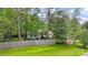 Green backyard with a wood fence and mature trees providing privacy and a serene outdoor setting at 301 Deer Creek Dr, Matthews, NC 28105