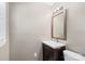 Bathroom featuring modern vanity with sink, toilet, decorative mirror, and neutral colors at 301 Deer Creek Dr, Matthews, NC 28105