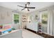 Bright bedroom featuring ceiling fan, hardwood floors, natural light, and organized bookshelves at 301 Deer Creek Dr, Matthews, NC 28105