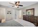 Bedroom featuring ceiling fan, large dresser and mirror, closet, and comfortable bed at 301 Deer Creek Dr, Matthews, NC 28105