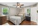 Comfortable bedroom with ceiling fan, hardwood floors, neutral colors, and natural light from the window at 301 Deer Creek Dr, Matthews, NC 28105