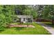 Charming white home featuring a well-manicured front yard and a long driveway at 301 Deer Creek Dr, Matthews, NC 28105