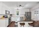 Modern kitchen featuring white cabinetry, stainless steel appliances, and an island with seating at 301 Deer Creek Dr, Matthews, NC 28105