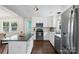 Updated kitchen with a functional island, stainless steel appliances, and bright white cabinetry at 301 Deer Creek Dr, Matthews, NC 28105