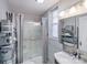 Bathroom featuring glass shower, gray walls, and storage at 301 W 10Th W St, Charlotte, NC 28202