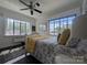 Bright bedroom with large windows, ceiling fan and dark rug at 301 W 10Th W St, Charlotte, NC 28202