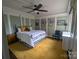 A bedroom features a large bed, a ceiling fan, and decorative wall trim at 301 W 10Th W St, Charlotte, NC 28202