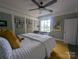 A bedroom features a large bed, a ceiling fan, and green colored walls at 301 W 10Th W St, Charlotte, NC 28202