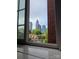 This window frames a view of the city skyline at 301 W 10Th W St, Charlotte, NC 28202