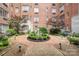 Beautiful brick courtyard featuring a center statue, manicured landscaping, and seating areas for relaxation and enjoyment at 301 W 10Th W St, Charlotte, NC 28202