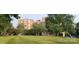 Exterior view of brick building with green lawn and mature trees at 301 W 10Th W St, Charlotte, NC 28202
