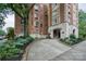 Exterior shot of a brick building, lush landscaping and circular driveway at 301 W 10Th W St, Charlotte, NC 28202