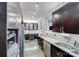 A kitchen features stainless steel appliances, granite counters, and dark cabinets at 301 W 10Th W St, Charlotte, NC 28202
