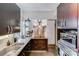 The kitchen includes stainless appliances, granite counters, and open shelves for storage at 301 W 10Th W St, Charlotte, NC 28202