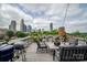 Spacious rooftop deck showcasing comfortable seating, grilling area, and breathtaking panoramic city views at 301 W 10Th W St, Charlotte, NC 28202