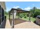 Backyard patio features outdoor seating with curtains, barbecue grill, and lush landscaping at 309 Kentmere Ln, Clover, SC 29710