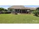 Lush backyard featuring a covered patio and well-maintained green lawn at 309 Kentmere Ln, Clover, SC 29710