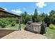 Outdoor kitchen and patio area with built-in grill, sink, and lush landscaping at 309 Kentmere Ln, Clover, SC 29710