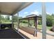 Cozy covered patio with outdoor seating, curtains and beautiful backyard view at 309 Kentmere Ln, Clover, SC 29710