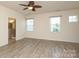 Spacious bedroom with neutral walls, plenty of windows for natural light, and modern ceiling fan at 309 Kentmere Ln, Clover, SC 29710