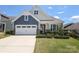 Charming home featuring a two-car garage, stone accents and manicured lawn at 309 Kentmere Ln, Clover, SC 29710