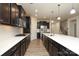Modern kitchen features dark cabinetry, stainless steel appliances, and a spacious island with white countertop at 309 Kentmere Ln, Clover, SC 29710