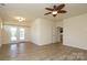 Bright, open-concept living area features a ceiling fan, wood-look floors, and french doors leading to the outdoors at 309 Kentmere Ln, Clover, SC 29710