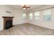 Living room with a fireplace and plenty of natural light with windows and wood-look flooring at 309 Kentmere Ln, Clover, SC 29710