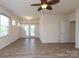 Living room with neutral walls and wood-look flooring, featuring a door that leads to the back at 309 Kentmere Ln, Clover, SC 29710
