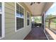 Relaxing screened-in porch features wood-look floors, ceiling fan and view of backyard at 309 Kentmere Ln, Clover, SC 29710