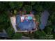 Aerial view of a luxury home with a pool, hot tub, garden and solar panels on roof at 3314 Leamington Ln, Charlotte, NC 28226
