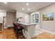 Finished basement bar area with seating, a custom cabinet, and modern finishes, ideal for entertaining at 3314 Leamington Ln, Charlotte, NC 28226
