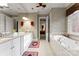 Luxurious bathroom with granite vanity, soaking tub, and elegant patterned wallpaper at 3314 Leamington Ln, Charlotte, NC 28226