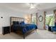 Bedroom with vibrant floral curtains, a ceiling fan, and a comfortable bed at 3314 Leamington Ln, Charlotte, NC 28226
