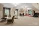 Expansive bonus room with versatile seating, natural light, and a unique stage area at 3314 Leamington Ln, Charlotte, NC 28226