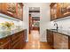 Elegant butler's pantry with custom cabinetry, granite countertops, and access to kitchen at 3314 Leamington Ln, Charlotte, NC 28226